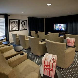 A cozy home theater with comfortable seating and popcorn ready for a movie night.