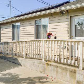 A single-story house with a ramp and railing for accessibility.