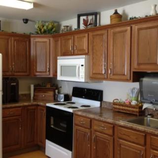 A cozy kitchen with wooden cabinets and modern appliances.