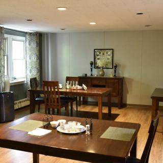A cozy dining room with wooden tables and chairs, elegantly arranged.
