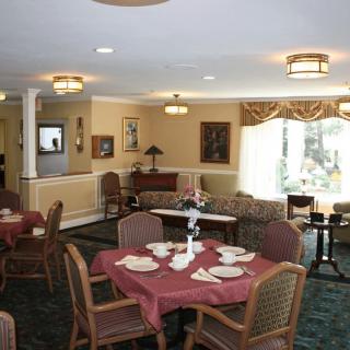 A cozy dining room with neatly arranged tables and chairs, set for guests.