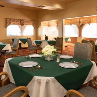 A cozy dining room with tables elegantly set for guests.