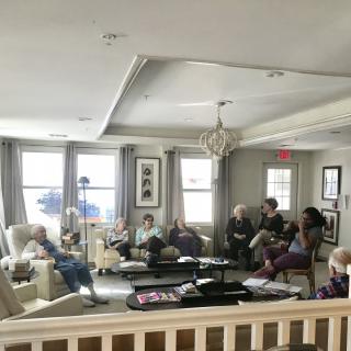 A group of people gathered in a cozy living room setting.