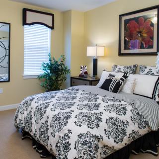 A well-decorated bedroom with a floral theme and modern furnishings.