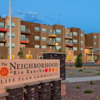 The Neighborhood in Rio Rancho is a life plan community featuring a modern residential building and well-maintained landscaping.