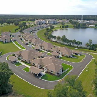 Aerial view of a suburban neighborhood with houses surrounding a lake.