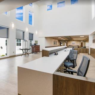 A modern and spacious office reception area with sleek furniture and large windows.