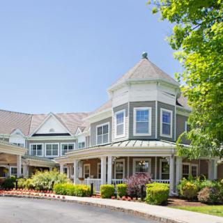 A charming residential building with a well-maintained garden and a sunny exterior.