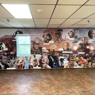 A vibrant mural showcasing a collage of iconic figures from film and entertainment.