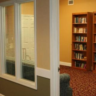 A cozy library room with bookshelves and a window view.