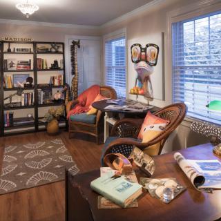 Cozy living room with bookshelves and colorful decor.