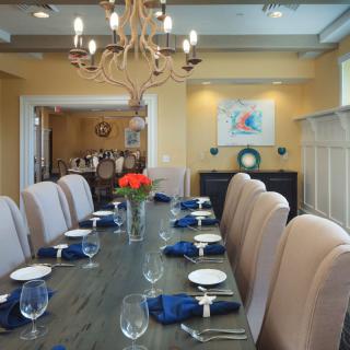 Elegant and formal dining room with a long table set for guests.