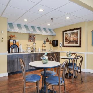 A cozy cafe area with seating and a coffee station.