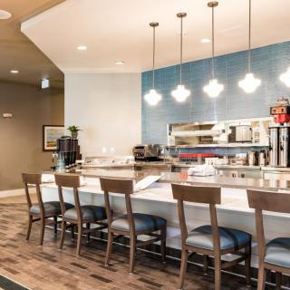 A modern restaurant with bar seating and stylish pendant lighting.