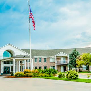 A welcoming entrance to a hotel with an American flag proudly displayed.