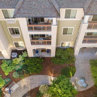 Aerial view of an apartment building with landscaped gardens and walkways.