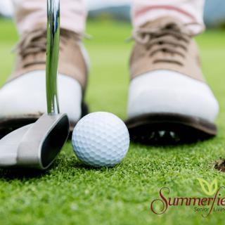 A close-up view of a golfer preparing to putt on the green.
