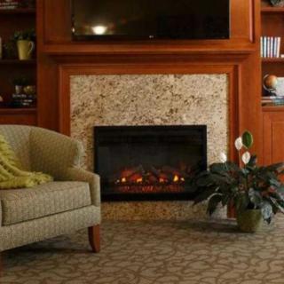 A cozy living room featuring a comfortable sofa, a fireplace, and elegant decor.