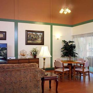 A cozy living room featuring a sofa, table, and decorative artwork.