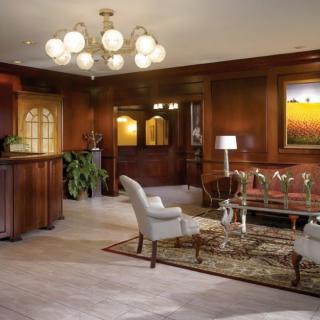 A luxurious lounge area with elegant furniture and a chandelier.