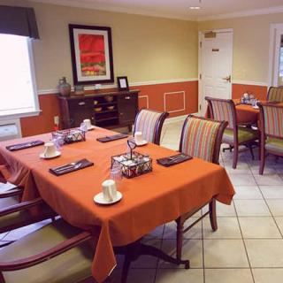 A cozy dining area with neatly set tables and chairs, ready for guests.