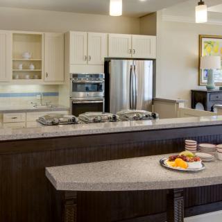 A modern kitchen with an island and stainless steel appliances.