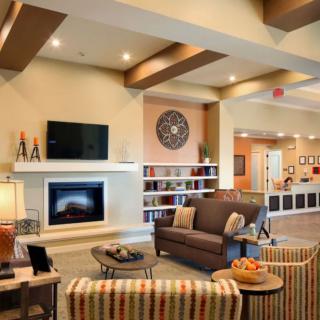 A cozy and modern living room with a fireplace and stylish furniture.