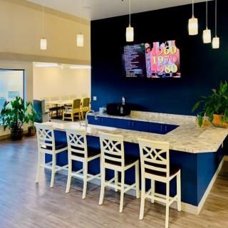 A modern bar area with stylish seating and pendant lighting.
