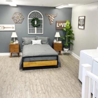 A modern, minimalist bedroom with stylish decor and neutral colors.
