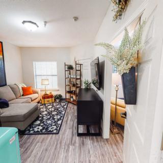 A modern living room with a cozy sofa, TV, and stylish decor.