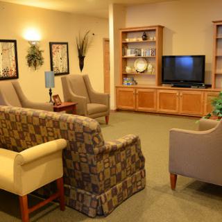 A cozy living room area featuring comfortable seating and a television.