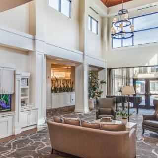 A spacious lobby area with comfortable seating and a grand piano.