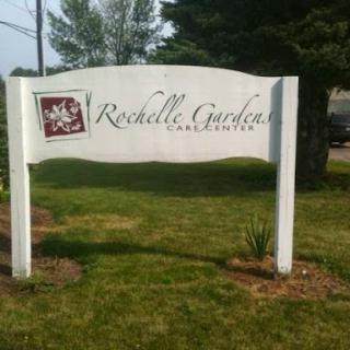 A welcoming sign for Rochelle Garden, a serene landscape area.