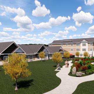 A scenic view of a modern building with landscaped gardens and pathways under a cloudy sky.
