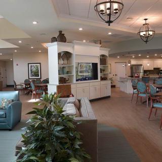 A spacious and elegantly designed living and dining area with stylish lighting and decor.