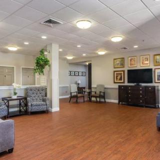 A welcoming lobby area with comfortable seating, modern decor, and a large TV.
