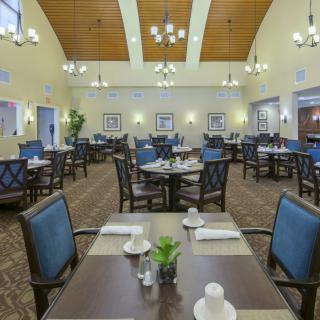 Spacious dining area with neatly arranged tables and elegant lighting.