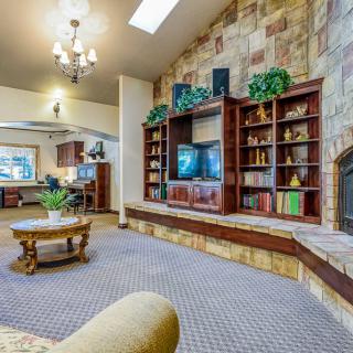 Cozy living room with bookshelves and a television.