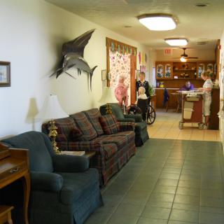 A cozy waiting area with seating and a reception desk in the background.