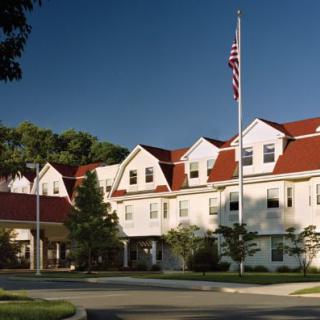 A building with a red roof and an American flag on a sunny day.