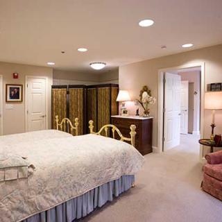 A cozy bedroom with elegant furniture and soft lighting.