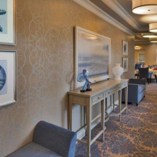 A well-decorated hallway with art and modern furnishings.