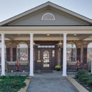 A traditional house with a welcoming front porch and classic columns.