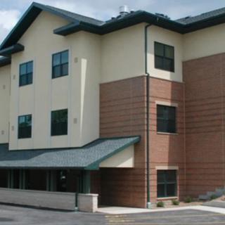 A modern commercial building with a mix of brick and stucco exterior.