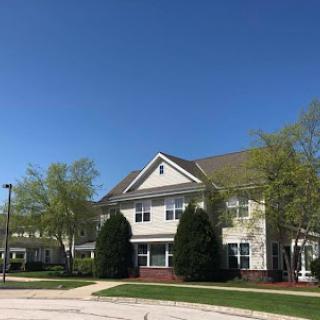A beautiful residential building under a clear blue sky.