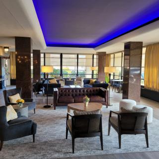 A modern lounge with stylish furniture and ambient lighting.