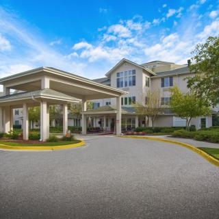 A welcoming entrance to a residential building against a blue sky.