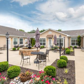 A beautifully landscaped courtyard with outdoor seating and a central fountain, perfect for relaxation.