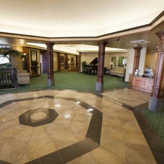 A spacious and elegantly designed lobby featuring polished flooring and welcoming decor.