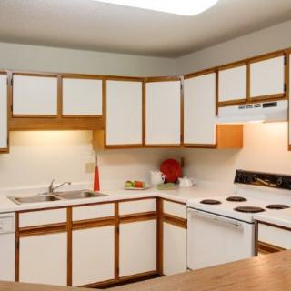 A cozy kitchen with wooden cabinets and modern appliances.